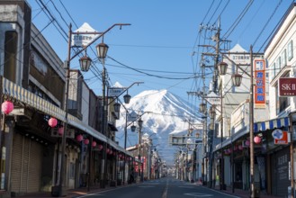 Road through the Japanese town of Fujiyoshida, behind the volcano Mt. Fuji, Yamanashi Prefecture,