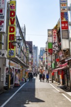 Street scene, lots of colorful signs of shops, restaurants and bars in a street, Shinjuku City,