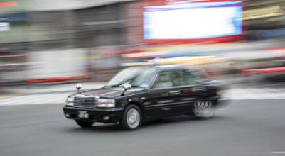 Black taxi driving, motion blur, long exposure, Shubuya Crossing, Shibuya, Tokyo, Japan