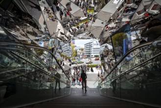 Young man on a stairway, entrance to a shopping center with many mirrors, Tokyu Plaza Omotesando