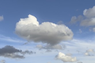 White Cumulus mediocris cloud against blue sky, lower left gray Cumulus fractus, international