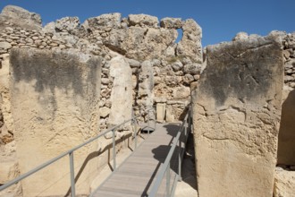 View from secured walkway with railing through ruins remains of Ggantija temple, UNESCO World