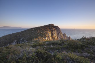 Sunrise hiking trail over the dramatic cliffs of Cape Hauy, Tasman Peninsula, Tasmania, Australia