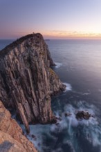 Totem Pole and The Lanterns. Long exposure at sunrise shows glowing dawn over the dramatic cliffs