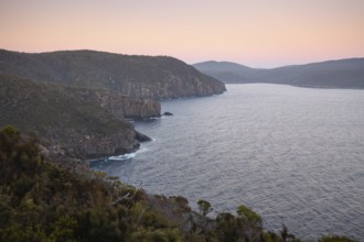 The Monument. Long exposure at sunrise shows glowing dawn over the dramatic cliffs of Cape Hauy.