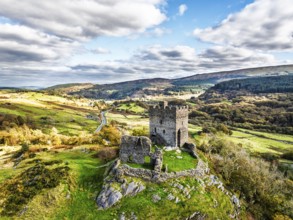 Autumn colours over Castell Dolwyddelan and Eryri Mountains from a drone, Snowdonia, Conwy County