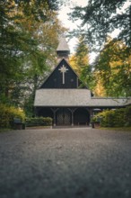 Wooden church in the forest, surrounded by trees in an atmospheric evening atmosphere, Altensteig,