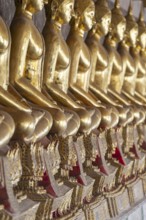 Gilded Buddha statues (Bhumispara mudra: Buddha Gautama at the moment of enlightenment), Wat Suthat