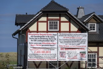 Accusatory posters about donation scandals at a house on the Darß, Meckelnburg-Western Pomerania,