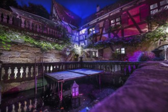 Historic inn, around 1623 with courtyard and fish pond in the evening, Rockenbrunn, Mittelfranklen,