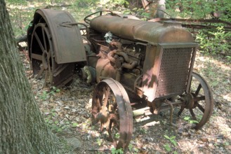 Rusted American Fordson tractor around 1900, dumped in a wooded area, Marksboro, New Jersey, USA
