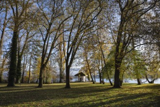 The Mettnaupark surrounded by autumn vegetation with the certificate house on the banks of Lake