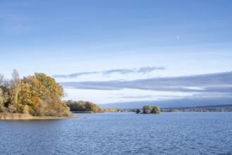 View of Lake Constance with Love Island, surrounded by autumn vegetation, on the horizon the island