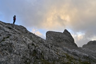 Mountaineer enjoys solitude in the Steinernes Meer with a view of the summit of Wildalmkirchl,