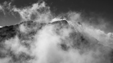 View from Brandhorn to the summit of the Hochkönig with the Matrashaus and atmospheric clouds,