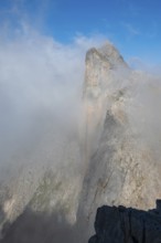 Summit of Wildalmkirchl with steeply sloping rock face surrounded by clouds, Steinernes Meer,