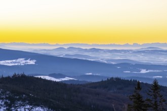 View from Mount Lusen over the hills of the bavarian forest at sunrise in winter, Bavaria, Germany