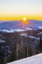 Sunrise over the hills of czech republic from Mount Lusen wth the view over the hills of the