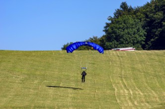 Skydivers during an aerial acrobatic performance as part of an air show at the Fliegerbergfest of