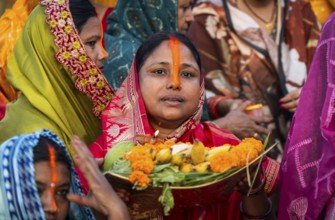 Hindu devotees offer prayers to the Sun God on the bank of Brahmaputra river on the occasion of