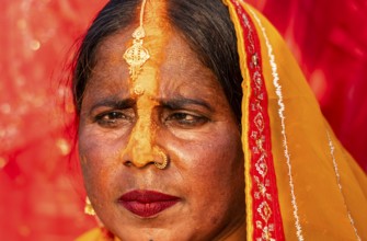 A Hindu devotee offer prayers to the Sun God on the bank of Brahmaputra river on the occasion of