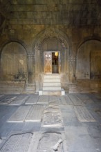 Stone burial chamber with carved tombstones and door to the interior, Noravank Monastery, Surb