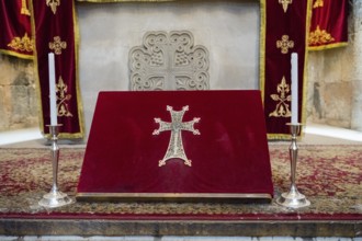 Red altar with golden cross and candle holders, religious site, Noravank monastery, Surb Karapet