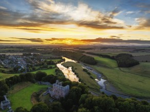 Sunset over Norham Castle and River Tweed from a drone, Norham, Northumberland, England, United