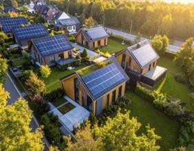 Aerial view showcases modern houses with solar panels and green roofs in a suburban setting,