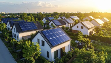 Aerial view showcases modern houses with solar panels and green roofs in a suburban setting,