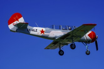 A Jakovlev Jak-52 with registration LY-HLZ during a flight demonstration as part of an air show on