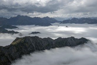 View from the Nebelhorn summit to mountains of the Allgäu Alps, mountains rising from fog in the