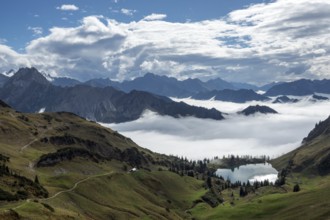 View of Seealpsee and Allgäu Alps, mountains rising from fog in the valley, Nebelhorn, Oberstdorf,