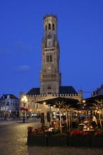 Illuminated Belfry in the historic city centre of Bruges in the evening light, Belfort and City