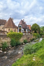 Picturesque Kaysersberg with half-timbered houses on the Weiss river in the old town centre