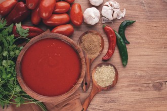 Georgian sauce, Satsebeli sauce, tomato and sweet pepper sauce, with spices, in a wooden bowl,