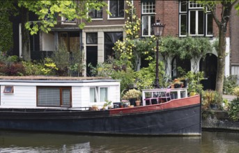 Holland, Amsterdam canals with boats, scenic bridges and historic city center, UNESCO World
