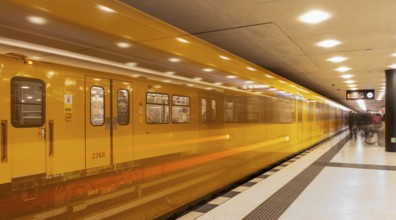 Dynamic scene of a Berlin underground in typical yellow colour, long exposure with blur effect,
