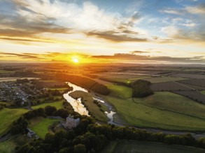 Sunset over Norham Castle and River Tweed from a drone, Norham, Northumberland, England, United