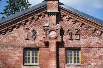 Brick façade with inscription 1893, former paper factory and mill for the production of groundwood