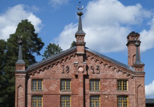 Multi-storey brick façade with inscription 1893, former paper factory and mill for the production