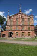 Multi-storey brick façade with inscription 1893, former paper factory and mill for the production