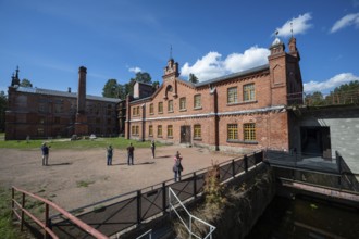 Visitors in front of the former paper mill and groundwood pulp board mill, UNESCO World Heritage