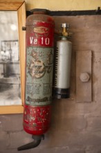 Old, rusty fire extinguisher from the Sisu company, former paper factory and mill for the