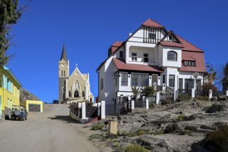 Colonial house facade in the Kirchstraße, in the background the rock church, Lüderitz, Karas