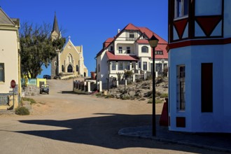 Colonial house facade in the Bergstraße, in the background the rock church, Lüderitz, Karas region,