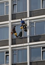 Two male glass cleaners abseiling down the hotel façade to clean windows, aletto Hotel Kudamm,