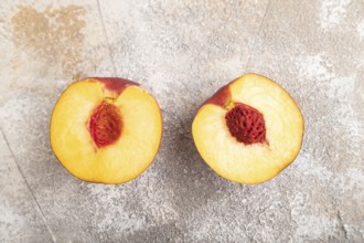 Peach Cut in half on brown concrete background. Top view, flat lay, close up. healthy food,