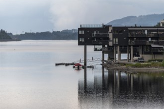 Modern residential building on the shore of Lake Mjosa with a jetty, Eidsvoll, Akershus, Norway