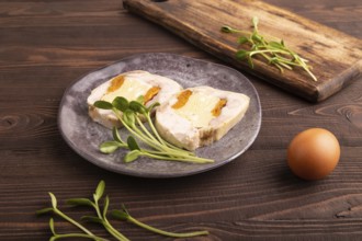 Chicken, egg and dried apricot meatloaf, microgreen on brown wooden. Diet, healthy eating. side